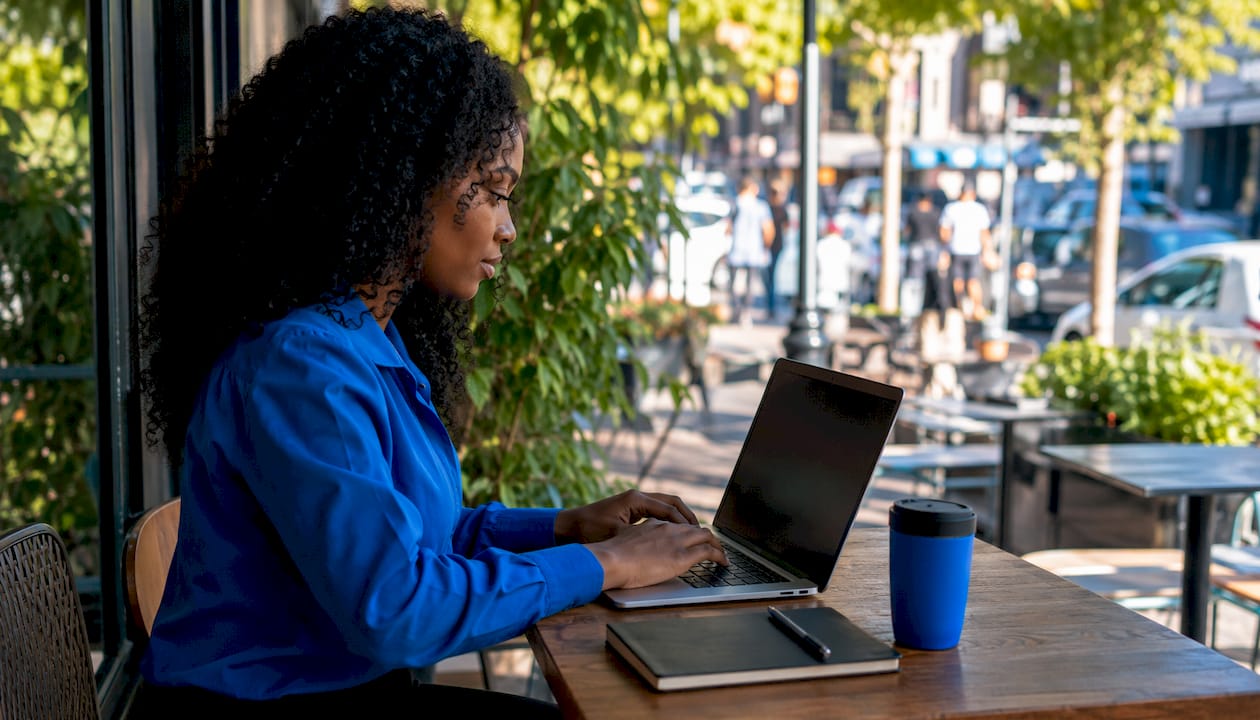 Woman using browser-based RDP proxy on laptop