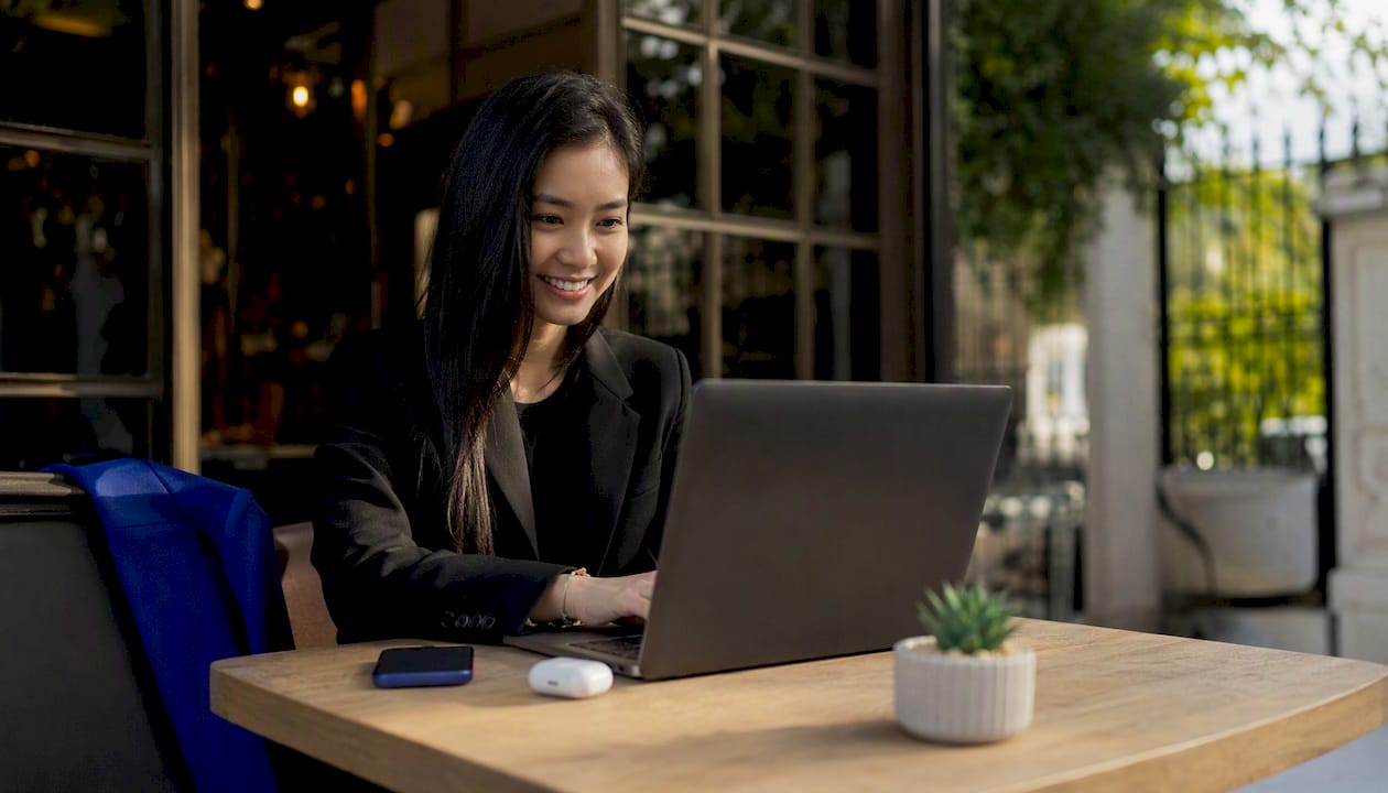 Woman at coworking space using VPN laptop
