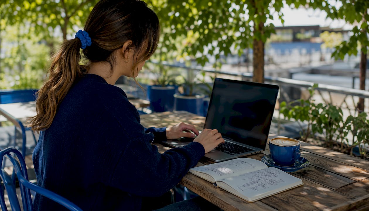 Hands typing VPN DNS filtering on laptop side profile